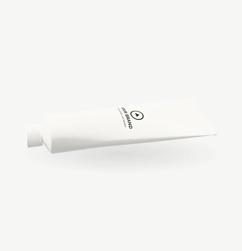 A white toothpaste tube lying on its back with brand artwork